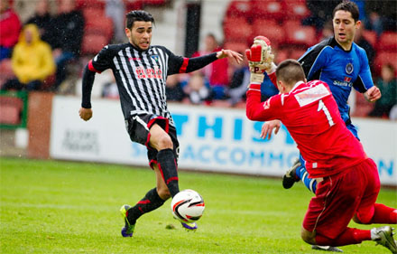 Faissal El Bakhtaoui slipps the ball past David Mitchell Faissal El Bakhtaoui slipps the ball past David Mitchell