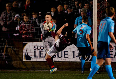 Ryan Scully saves at the boot of Sean Higgins Ryan Scully saves at the boot of Sean Higgins