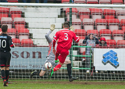 Ryan Scully blocks Darren Petrie`s shot Ryan Scully blocks Darren Petrie`s shot
