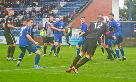 Robert Thomson tries to head home