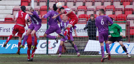 Blair Henderson clears from a Ross County corner near the end of the match